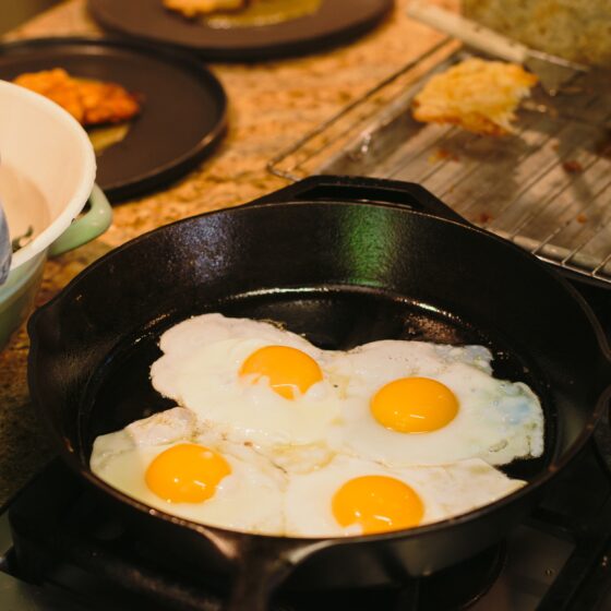 eggs frying in an iron skillet