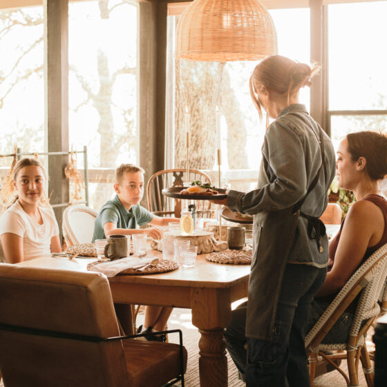 Chef Dominique Benavidez serving guests breakfast